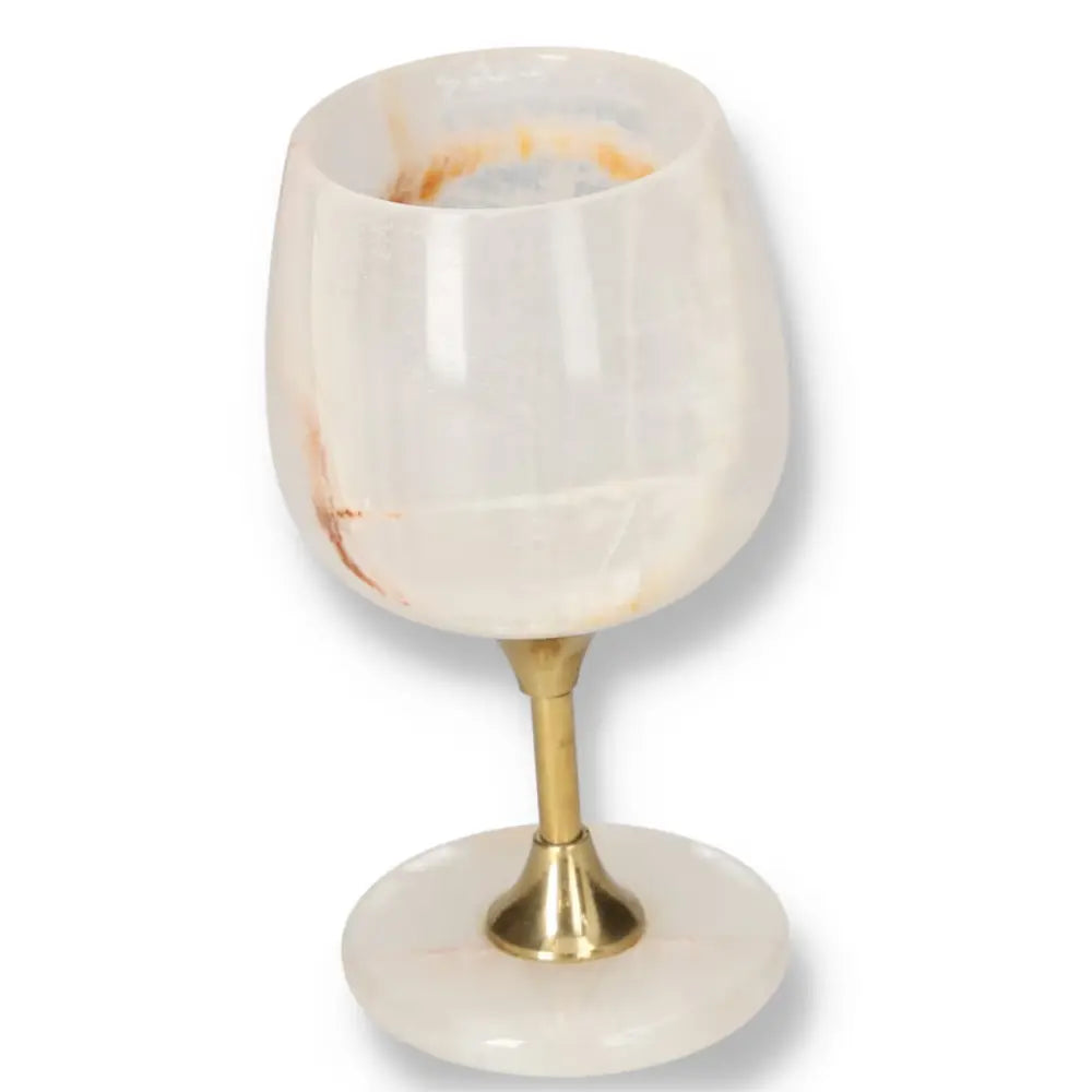 Elegant off-white onyx wine glass with unique veining and polished finish on a gold stem, perfect for refined occasions.