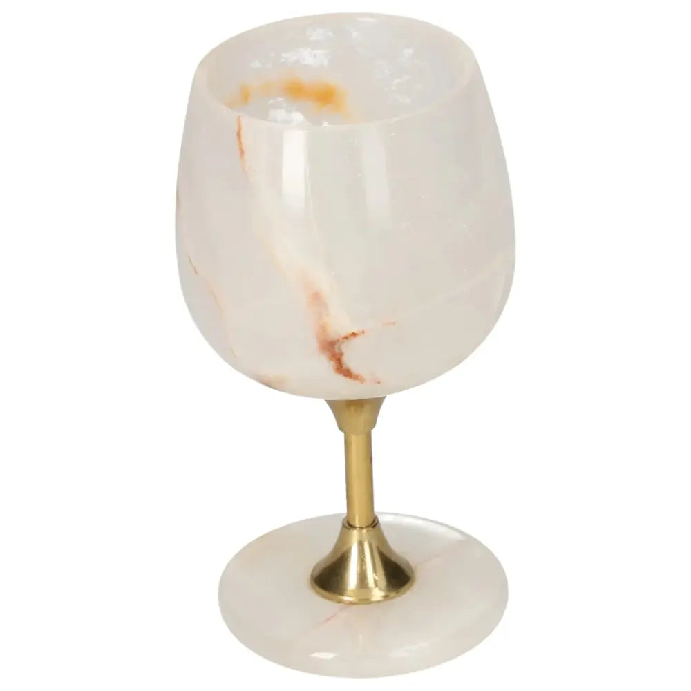 Elegant onyx wine glass with unique color and veining, gold stem, and polished surface showcasing refined craftsmanship.
