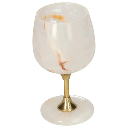 Elegant onyx wine glass with unique color and veining, gold stem, and polished surface showcasing refined craftsmanship.