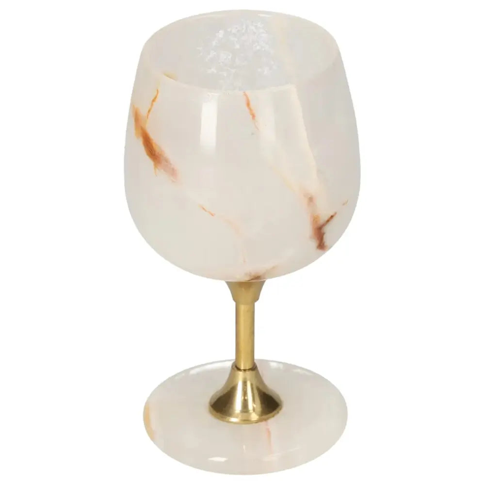 Onyx wine glass with a brass stem, featuring unique off-white color and veining, showcasing elegance. Ideal for sophisticated occasions.