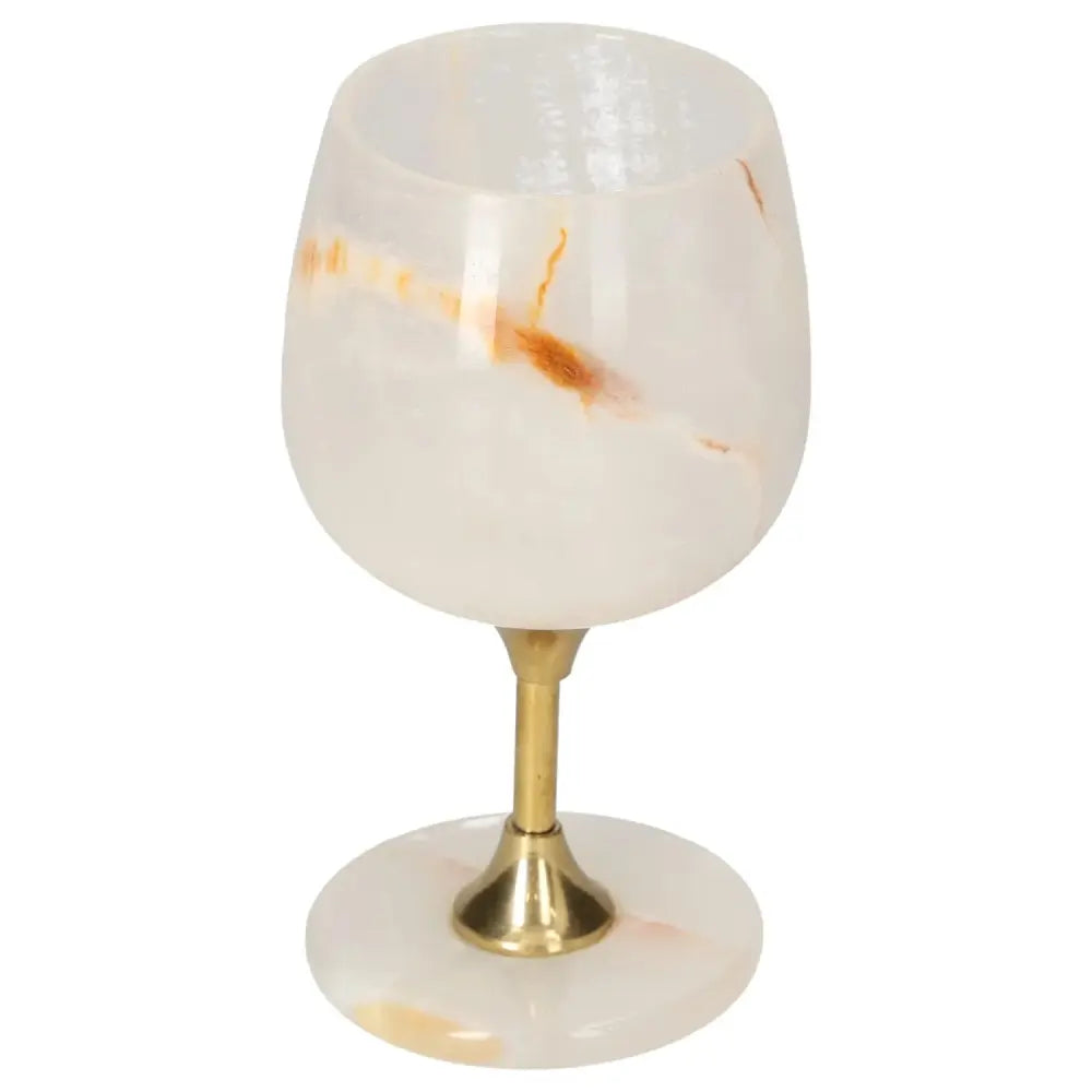 Exquisite onyx wine glass with gold stem, showcasing unique off-white veining and polished surface for a sophisticated touch.
