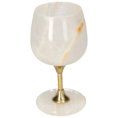 Elegant onyx wine glass with unique veining, featuring a polished surface and gold stem, perfect for sophisticated occasions.