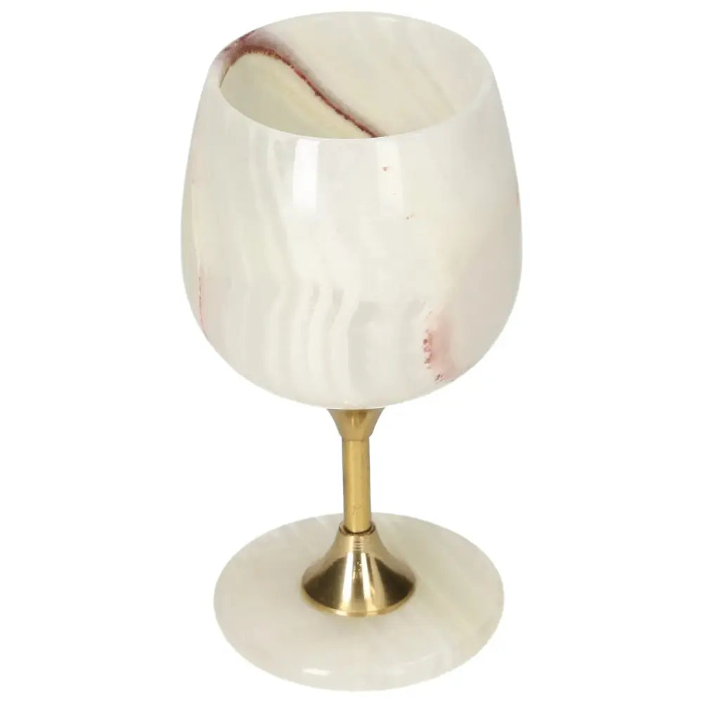 Exquisite onyx wine glass with unique veining, polished off-white surface, and elegant gold stem, ideal for sophisticated gatherings.