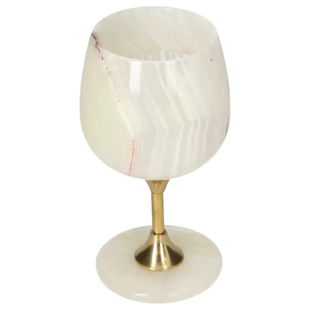 Elegant onyx wine glass with brass stem, featuring unique off-white color and natural veining, perfect for sophisticated occasions.