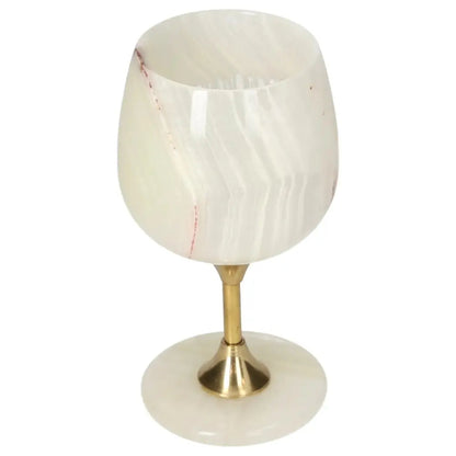 Elegant onyx wine glass with brass stem, featuring unique off-white color and natural veining, perfect for sophisticated occasions.