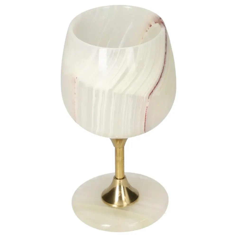 Elegant onyx wine glass with gold stem, showcasing unique veining and polished surface, perfect for sophisticated occasions.