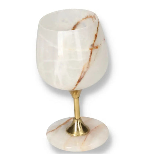Exquisite onyx wine glass with unique veining, polished surface, and gold stem, exemplifying elegance and natural allure.