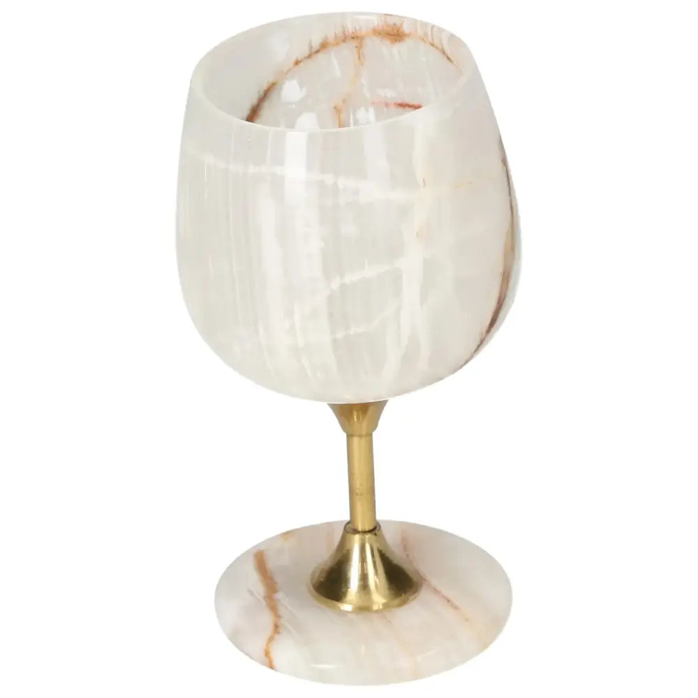 Exquisite off-white onyx wine glass with unique veining and gold stem, highlighting elegance and sophistication for fine drinking.