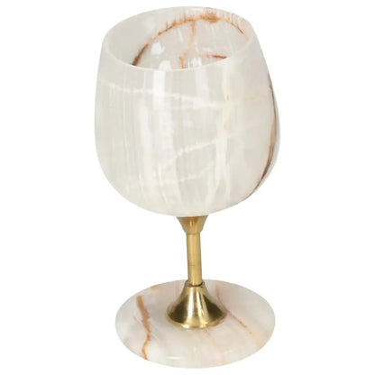 Exquisite off-white onyx wine glass with unique veining and gold stem, highlighting elegance and sophistication for fine drinking.