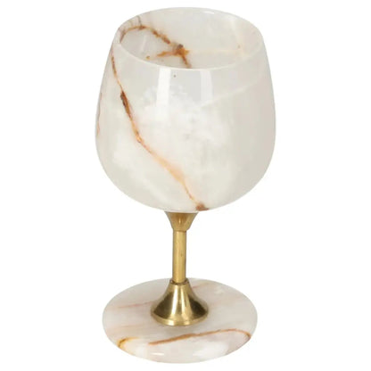 Elegant onyx wine glass with gold stem, showcasing natural veins and polished off-white surface, exuding sophistication and charm.