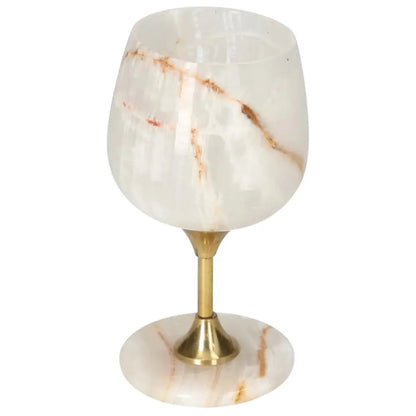 Elegant onyx wine glass with unique veining patterns, featuring a polished off-white finish and a sophisticated gold stem.