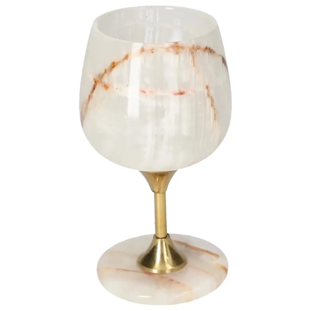 Elegant onyx wine glass with unique veining, polished surface, and golden stem, perfect for sophisticated occasions.