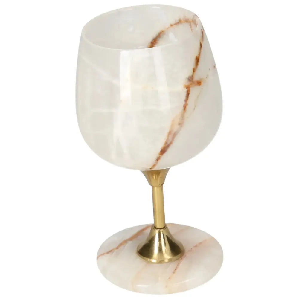 Elegant onyx wine glass with brass stem, showcasing unique off-white color and veining ideal for sophisticated gatherings.