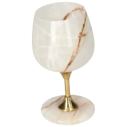 Elegant onyx wine glass with brass stem, showcasing unique off-white color and veining ideal for sophisticated gatherings.