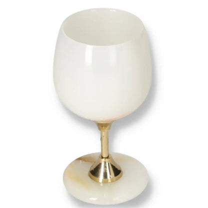 Elegant onyx wine glass with a gold stem, showcasing unique off-white color and veining. Perfect for sophisticated occasions.