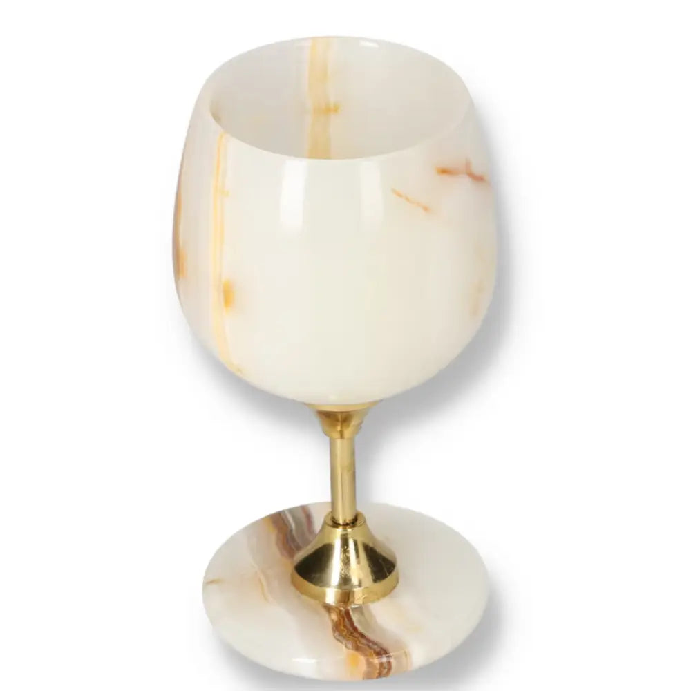 Exquisite off-white onyx wine glass with unique veining and polished surface, featuring a gold stem, perfect for sophisticated occasions.