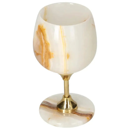Exquisite onyx wine glass with unique veining and polished surface, crafted from premium off-white onyx for elegant drinkware.