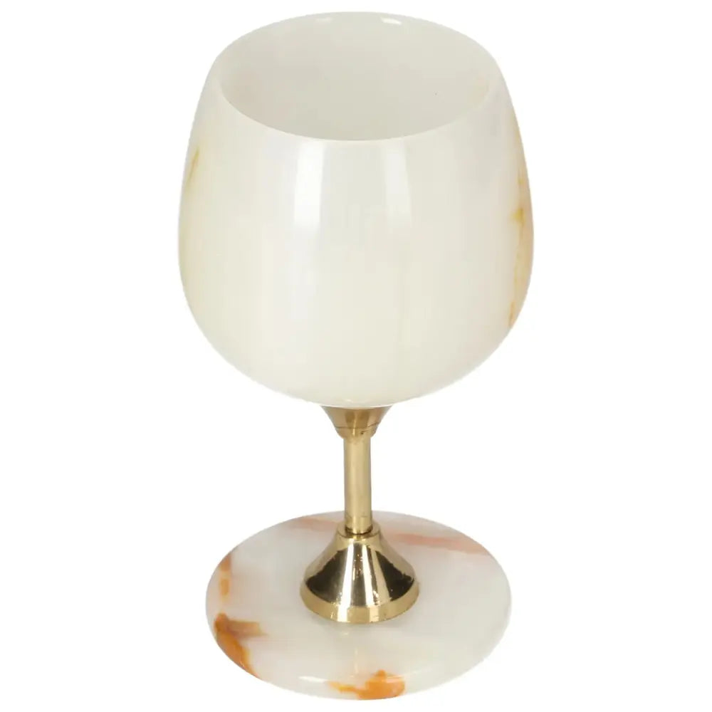 Elegant onyx wine glass with gold stem, showcasing unique off-white veining, ideal for sophisticated dining experiences.