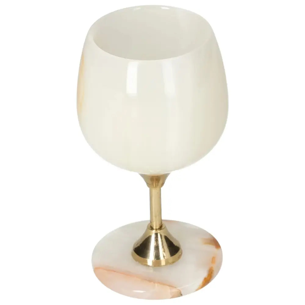Elegant onyx wine glass with polished off-white surface and unique veining, featuring a gold-toned stem; a luxurious drinking experience.