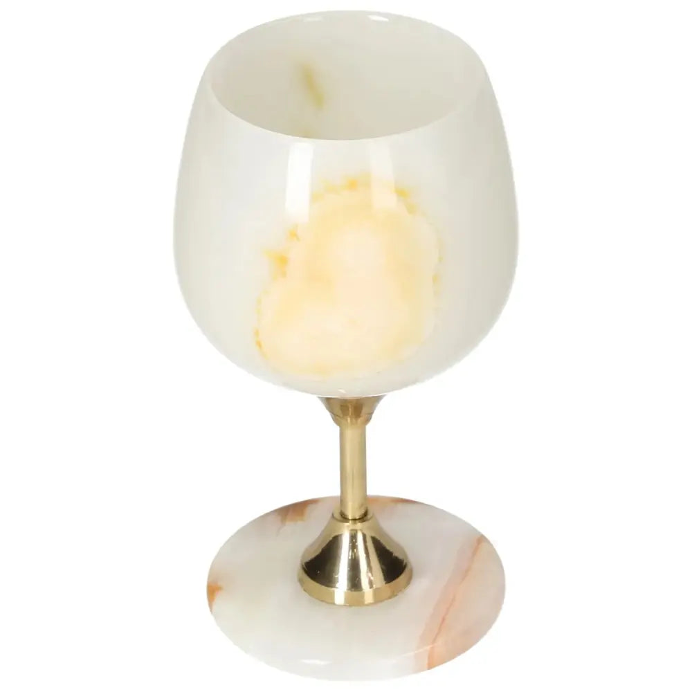 Exquisite onyx wine glass with unique off-white veining and a polished surface, featuring an elegant gold stem. Perfect for sophisticated occasions.