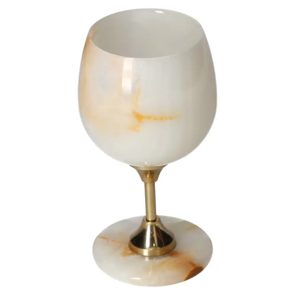 Elegant onyx wine glass with unique off-white veining, showcasing craftsmanship and luxury in fine dining.