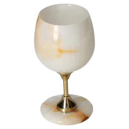 Elegant onyx wine glass with unique off-white veining, showcasing craftsmanship and luxury in fine dining.