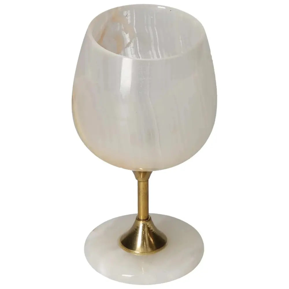 Exquisite onyx wine glass with gold stem and off-white veining, showcasing elegance and natural allure for sophisticated occasions.
