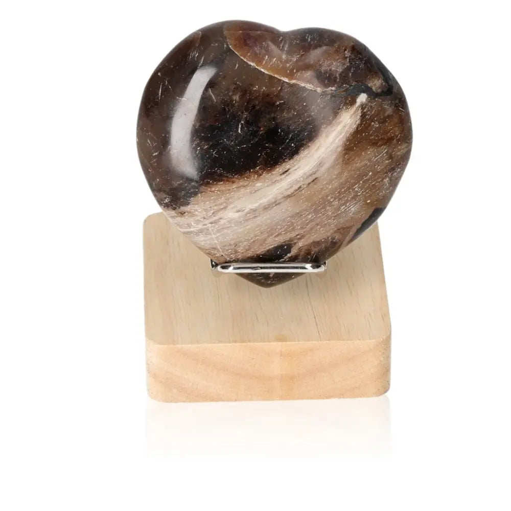 Heart-shaped Opal Verte crystal on a wooden stand, symbolizing love, passion, and encouragement; perfect for enhancing cosmic consciousness.