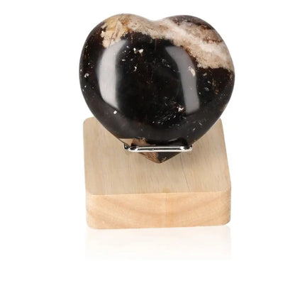Heart-shaped Opal Verte crystal on a wooden base, showcasing its mystical power to stimulate love and enhance cosmic consciousness.