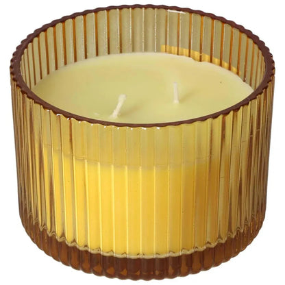 Patchouli Amber scented candle in a ribbed glass jar, crafted from natural soy wax for an eco-friendly burn, aligning with sustainable living.