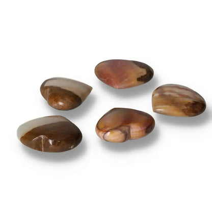 Polished peach calcite stones showcasing natural variations in color and texture, promoting inner peace and emotional renewal.