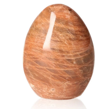 Smooth polished peach moonstone, showcasing soft peach hues, known for soothing emotions and promoting inner peace.