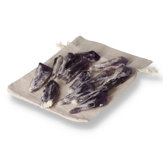Collection of Amethyst Tip crystals on fabric, enhancing luxury, spirituality, stress reduction, and concentration. Sylvia Crystals exclusive.