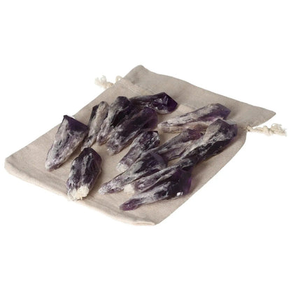 Collection of Amethyst Tips on a beige drawstring bag, ideal for stress relief and spiritual enhancement, by Sylvia Crystals.