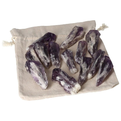 Collection of Amethyst Tip crystals on a linen bag, showcasing their deep purple hues and natural formations, enhancing spiritual allure.