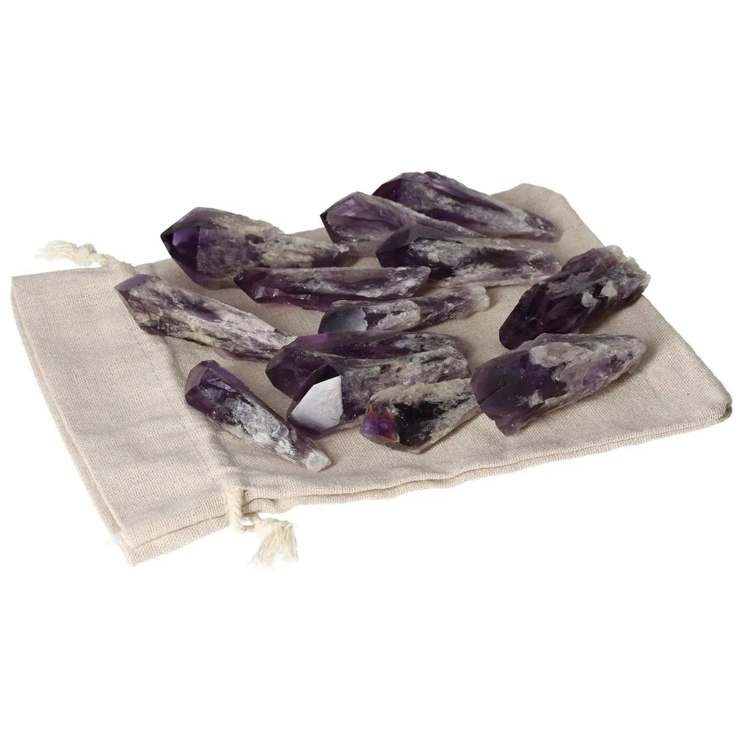 Amethyst Tips displayed on a beige cloth, promoting luxury, stress relief, and emotional stability by Sylvia Crystals.