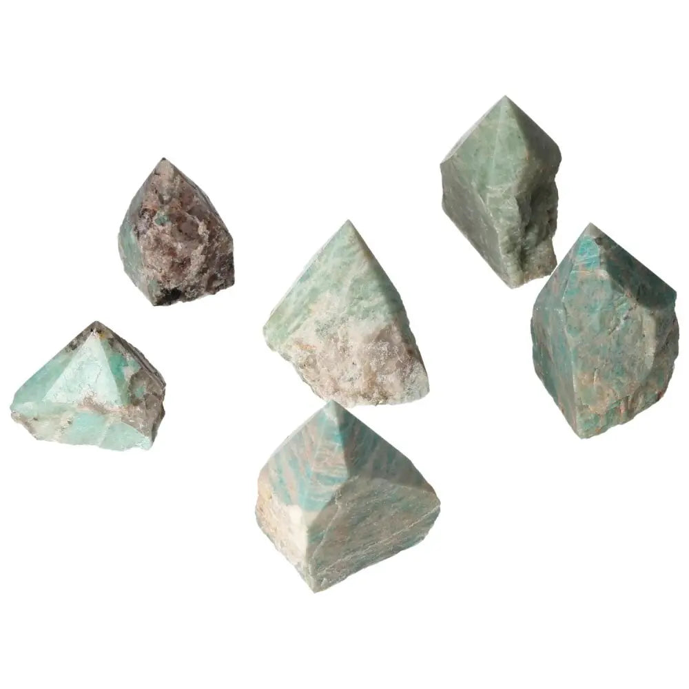 Collection of polished Amazonite crystals showcasing their unique shapes and calming green hues, embodying harmonious energy.
