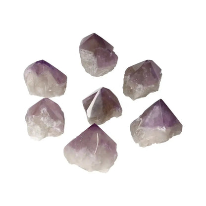 Polished Point Amethyst S crystals arranged in a circle, showcasing their clarity and radiant purple hues, ideal for stress relief and clarity.