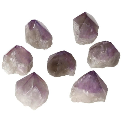 Seven polished point amethysts from Sylvia Crystals, showcasing premium quality and calming properties.