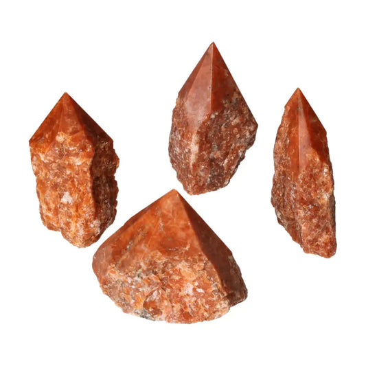 Four polished fire calcite points from Sylvia Crystals, showcasing vibrant orange and red hues, symbolizing vitality and determination.