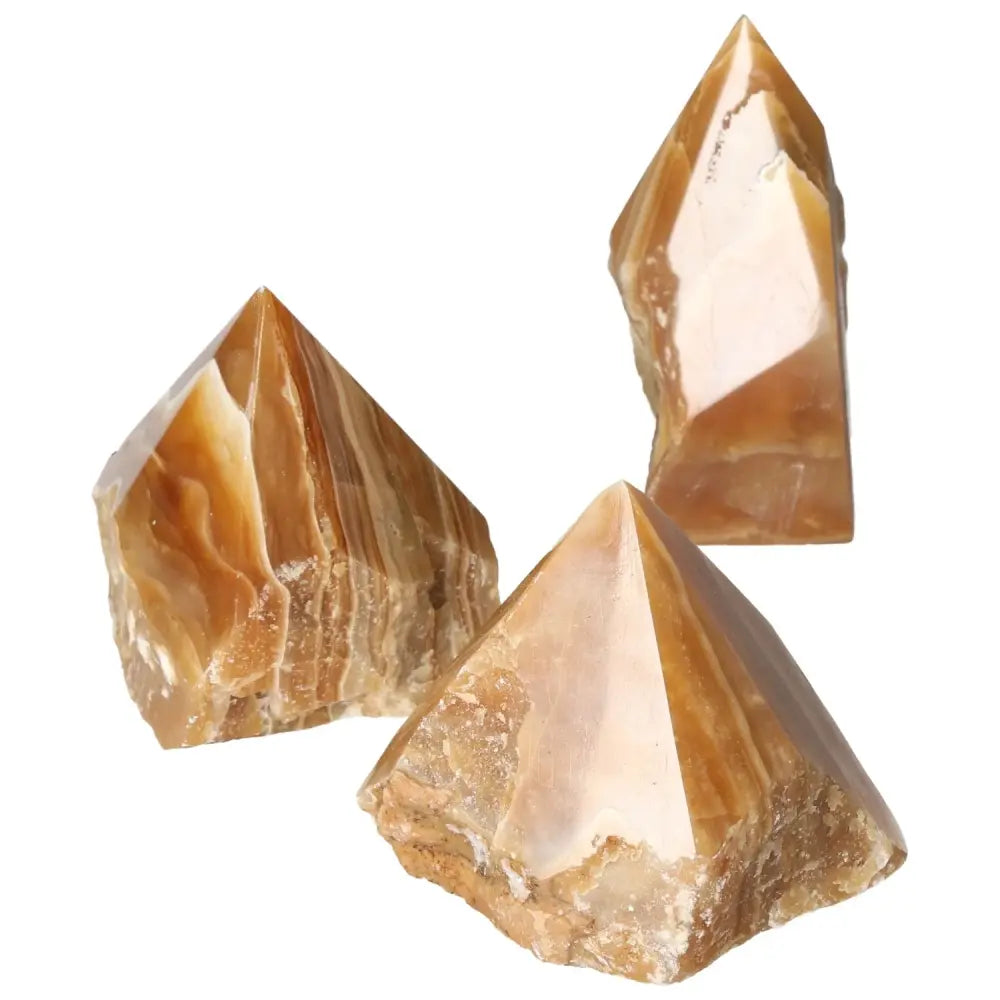 Polished Point Honey Calcite L gemstones with warm amber hues, promoting prosperity and success by Sylvia Crystals.