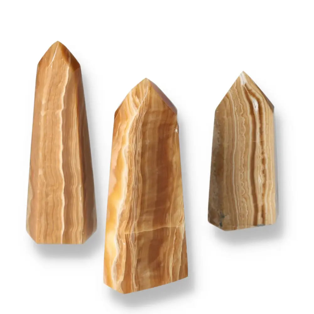 Polished Point Honey Calcite L crystals by Sylvia Crystals, showcasing a honey-colored hue and smooth surface for prosperity and luxury.