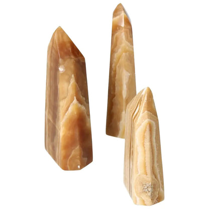 Polished Point Honey Calcite L by Sylvia Crystals, showcasing its smooth, honey-hued surface, symbolizing prosperity and abundance.
