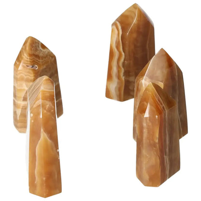 Polished Point Honey Calcite M crystals showcasing rich honey-like hues, symbolizing prosperity and emotional healing from Sylvia Crystals.