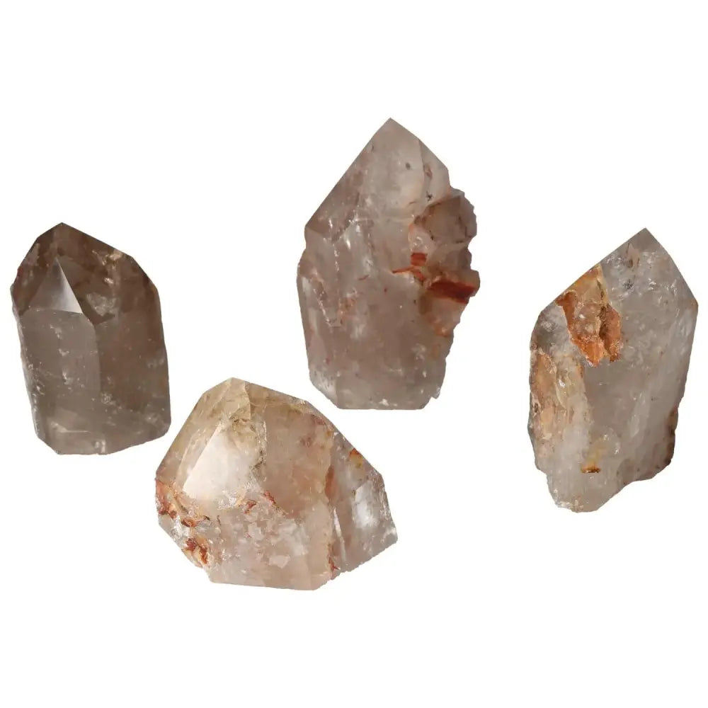 Four polished point quartz with hematite crystals from Sylvia Crystals showcasing their visual appeal and spiritual benefits.