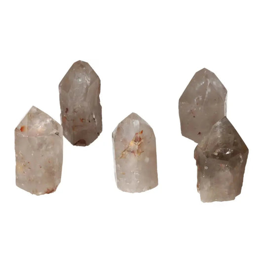 Polished Point Quartz with Hematite stones arranged for display by Sylvia Crystals, showcasing their natural elegance and transformative energy.