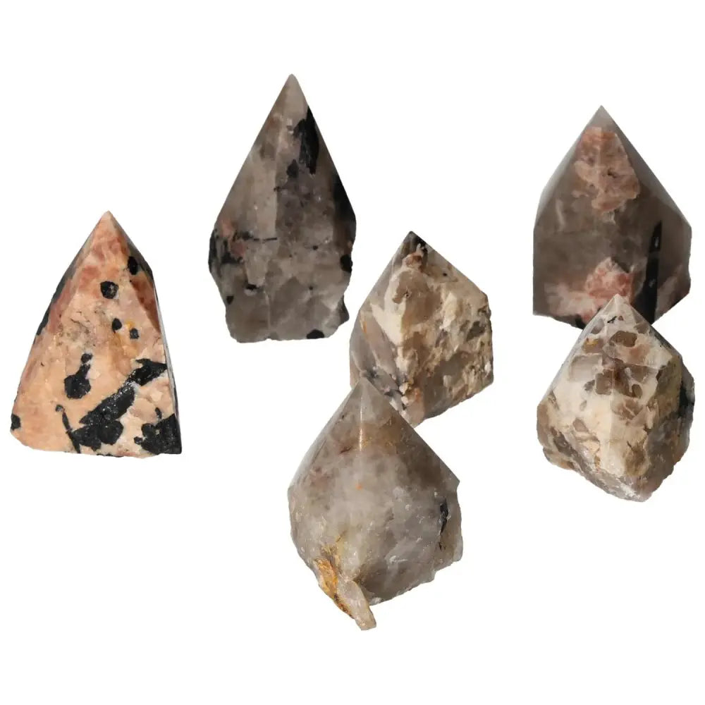 Polished Point Quartz crystals with striking black tourmaline inclusions, symbolizing luxury and elegance, showcased in Sylvia Crystals collection.