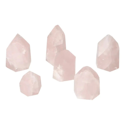 Collection of polished rose quartz obelisks in varying small sizes, highlighting their natural elegance and spiritual aura.