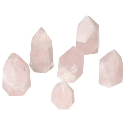 Collection of polished rose quartz obelisks, showcasing natural pink hues, ideal for enhancing space aesthetics and energy flow.