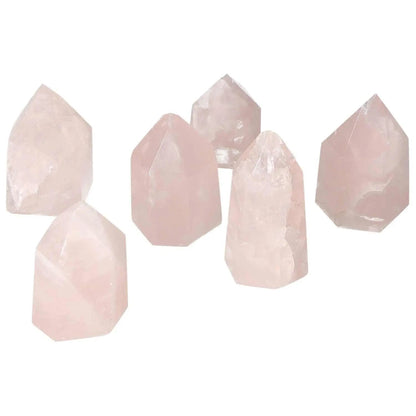 Set of six Polished Rose Quartz Obelisks XS, showcasing elegance and natural beauty by Sylvia Crystals, perfect for home decor.